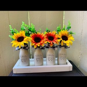 Farmhouse house style milk jugs centerpiece.